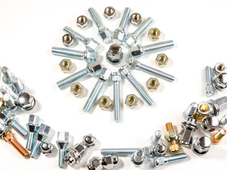 nuts and studs for a car on a table