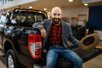 Happy man poses in the back of new pickup truck © Nomad_Soul