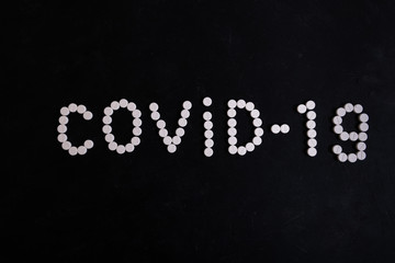 Word COVID-19 made from tablets. Coronavirus concept.