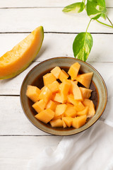 Cantaloupe melon in bowl on white background