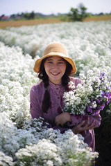 Woman holding flowers in Cutter flower fields at Mae Rim district, Chiang Mai, Thailand.