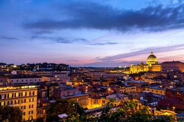 Fototapeta na wymiar Cityscape view of Rome at sunset with St Peter Cathedral in Vatican.