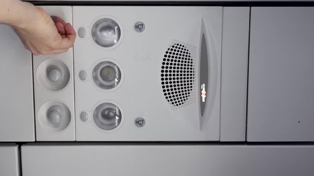 Air conditioning in an airplane. Man adjusts air conditioning in an airplane.