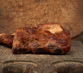 fried pork ribs on a brown wooden board