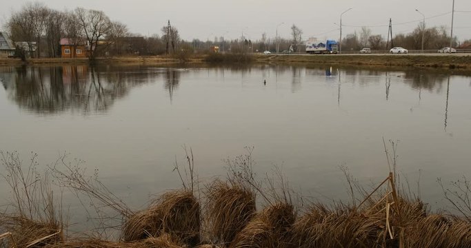 Small pond and old houses in the suburbs near Leningradskoye Shosse