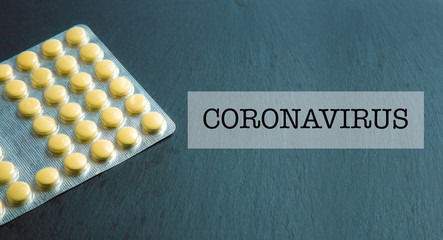 Medicaments in blister and Coronavirus inscription stock photo
