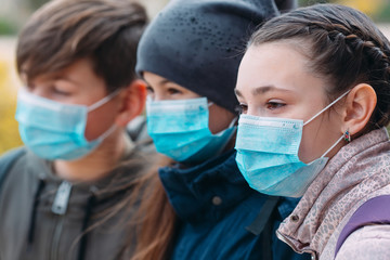 School-age children in medical masks. portrait of school children.