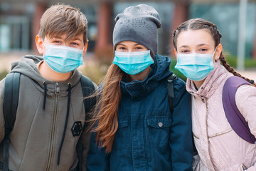 School-age children in medical masks. portrait of school children.
