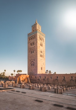 Koutoubia Mosque Minaret in Morocco Marrakesh and gardens during sunset with blue sky. Inside Medina. UNESCO World Heritage site.