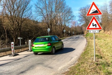 Car goes uphill. Road grade 12 per cent, road sign in Czech Republic near the village of Rikonin....