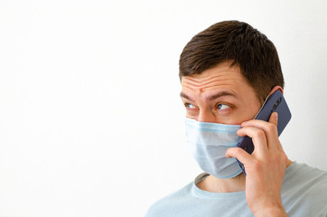 Coronavirus. Quarantine. A man solves work issues remotely. In the mask.