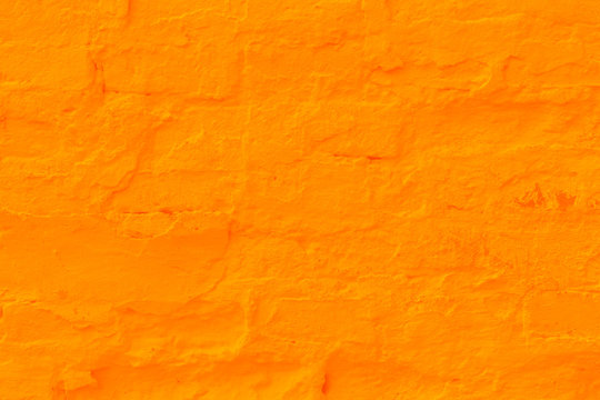 Saffron plastered brick wall texture.