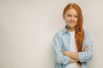 portrait of positive smiling child with natural red hair isolated over white background. happy beautiful pretty girl look at camera and smile. natural beauty concept