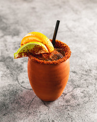 Traditional mexican alcoholic beverage in terra cota cup