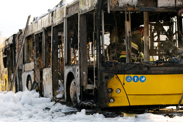 Burnt public traffic bus on street after caught in fire during travel and extinguished by...
