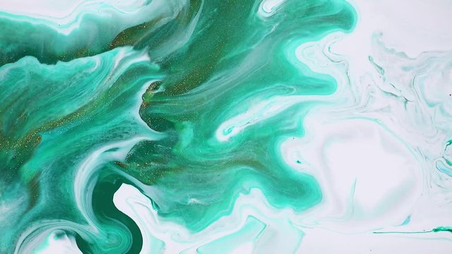 Fluid art painting video, abstract acryl texture with colorful waves. Liquid paint mixing backdrop with splash and swirl. Detailed background motion with green, white and emerald overflowing colors