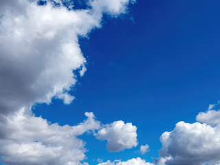 white puffy clouds in a bright blue sky