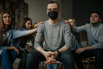 young caucasian man get virus, everyone want to help him, support and try to calm him down, he found out about severe deterioration in health. influenza, epidemy, help, virus, coronavirus concept