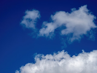 white puffy clouds in a bright blue sky