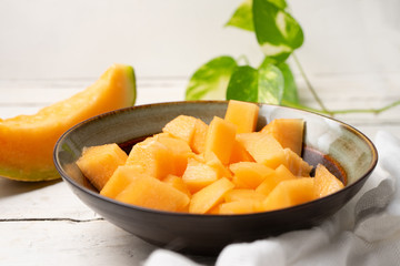 Cantaloupe melon in bowl on white background