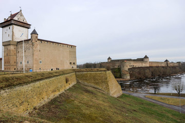 Fototapeta na wymiar View of medieval Hermann Castle opposite Ivangorod Fortress ,with Narva River in between