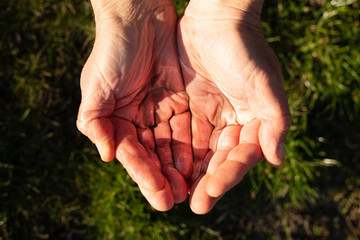 Man hands hold crystal clear water.