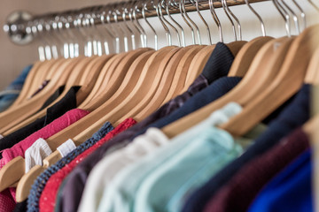 Lot of different clothes on hangers. Copy space