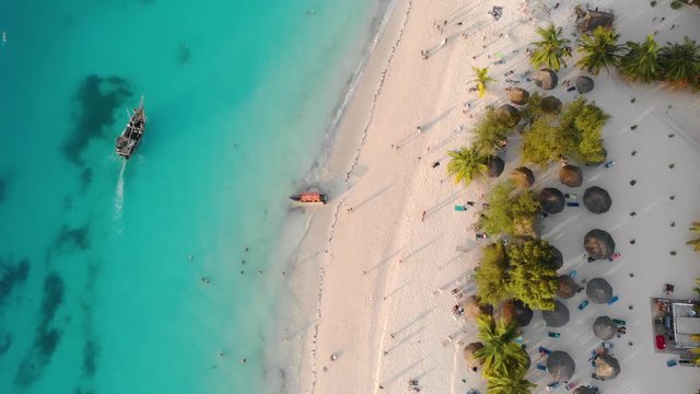 Top View on Beach Line with Resorts at Zanzibar Nungwi beach at evening time with blue Indian ocean