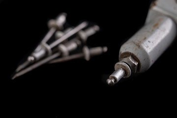 Riveting two pieces of metal sheet. Connecting steel with rivets.