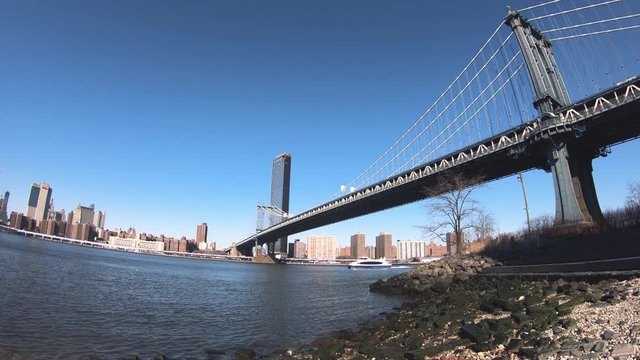 Brooklyn Bridge and Cityscape of New York skyline seen from the riverside in Dumbo.