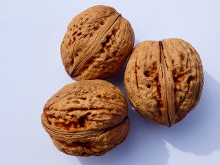 three walnuts on a white background