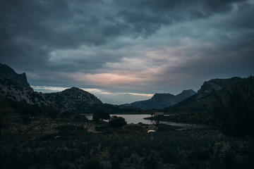 Fototapeta na wymiar mountain lake in moody atmosphere after sunset