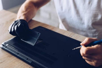 Technician installing new RAM module into the memory slot