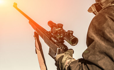 The man is on the hunt. Hunt hunting rifle. Hunter man. Hunting period. Male with a gun. Man holds...