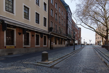 Empty street with closing shop, cafe and restaurant during quarantine from contagion of COVID-19 on walking street and plaza in old town in Düsseldorf, Germany.