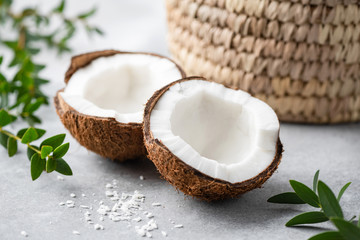 Halved coconut on concrete background. Healthy tropical nut