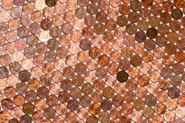 Full frame background of American pennies of varying ages and conditions formed into a neat pattern