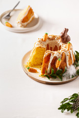 Easter lemon cake with icing and easter decoration. Easter gugelhupf cake with marzipan carrots and chocolate easter bunny