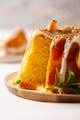 Easter lemon cake with icing and easter decoration. Easter gugelhupf cake with marzipan carrots and chocolate easter bunny