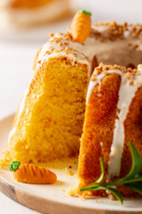 Easter lemon cake with icing and easter decoration. Easter gugelhupf cake with marzipan carrots and chocolate easter bunny