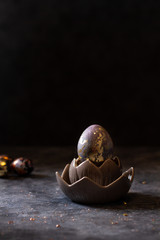 Golden egg. Easter golden egg in nest. Easter egg decoration with patina