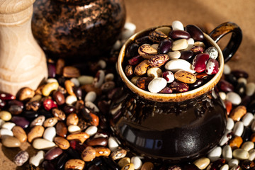Dried multi-colored kidney beans in clay cup, super food
