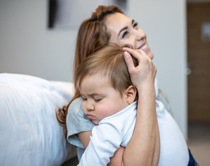 Mother hugging her beautiful preschooler son.