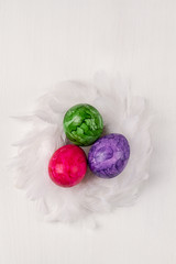 Easter eggs on white background. Colorful easter eggs in the nest