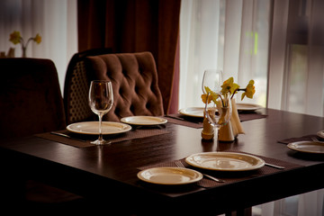 interior of the cafe, in the evening in brown tones, with dishes and furniture