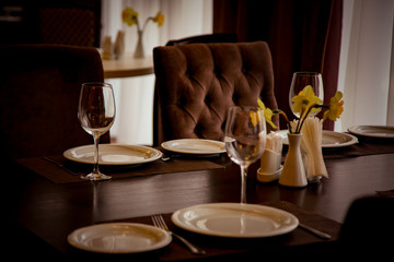 interior of the cafe, in the evening in brown tones, with dishes and furniture