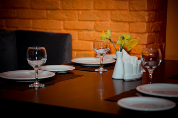interior of the cafe, in the evening in brown tones, with dishes and furniture