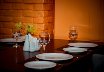 interior of the cafe, in the evening in brown tones, with dishes and furniture