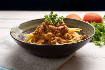 Spaghetti bolognese with parmesan cheese on white background