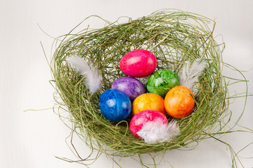Easter eggs on white background. Colorful easter eggs in the nest